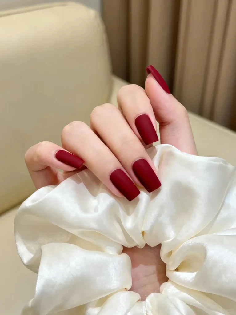 Vibrant red nails in square shape with glossy finish.