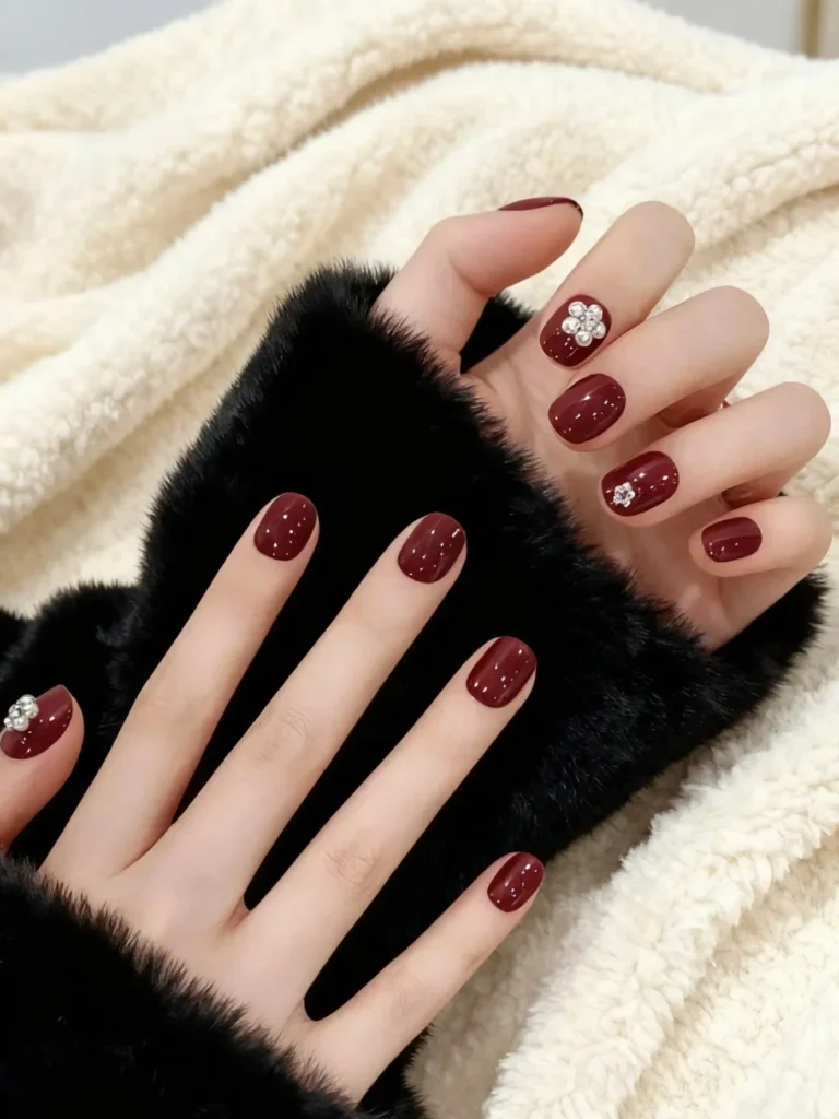 Classy fall nail designs with deep burgundy nails and a cozy autumn look.